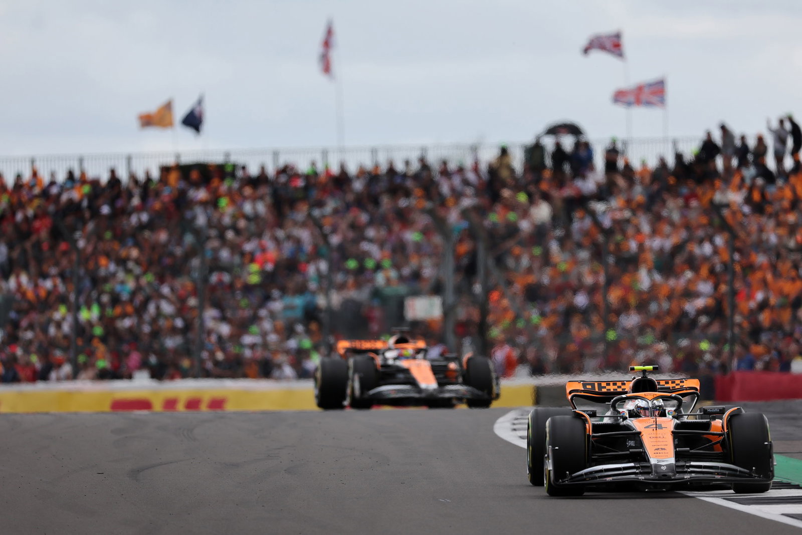 Lando Norris and Oscar Piastri driving for McLaren at the 2023 British Grand Prix.