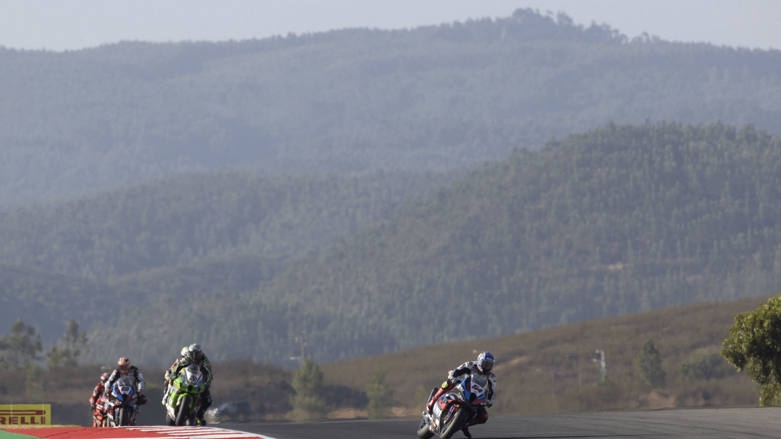 Toprak Razgatlioglu leads Alex Lowes, 2024 Portuguese WorldSBK. - Gold and Goose.