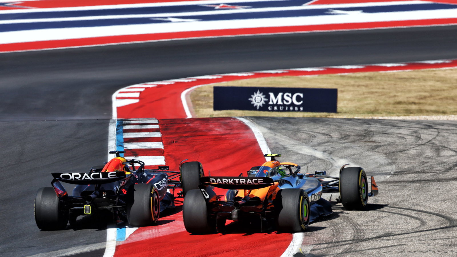 Max Verstappen runs Lando Norris out wide at the start 