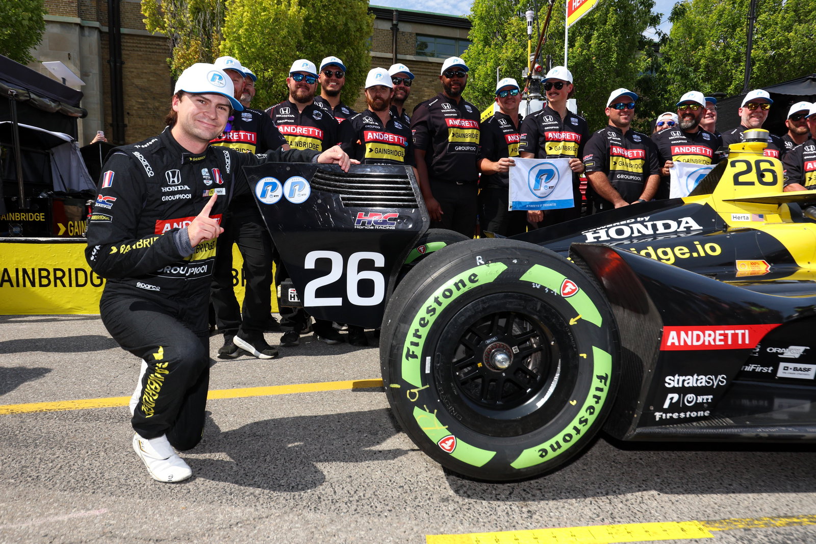 Colton Herta next to his car after pole at Toronto.