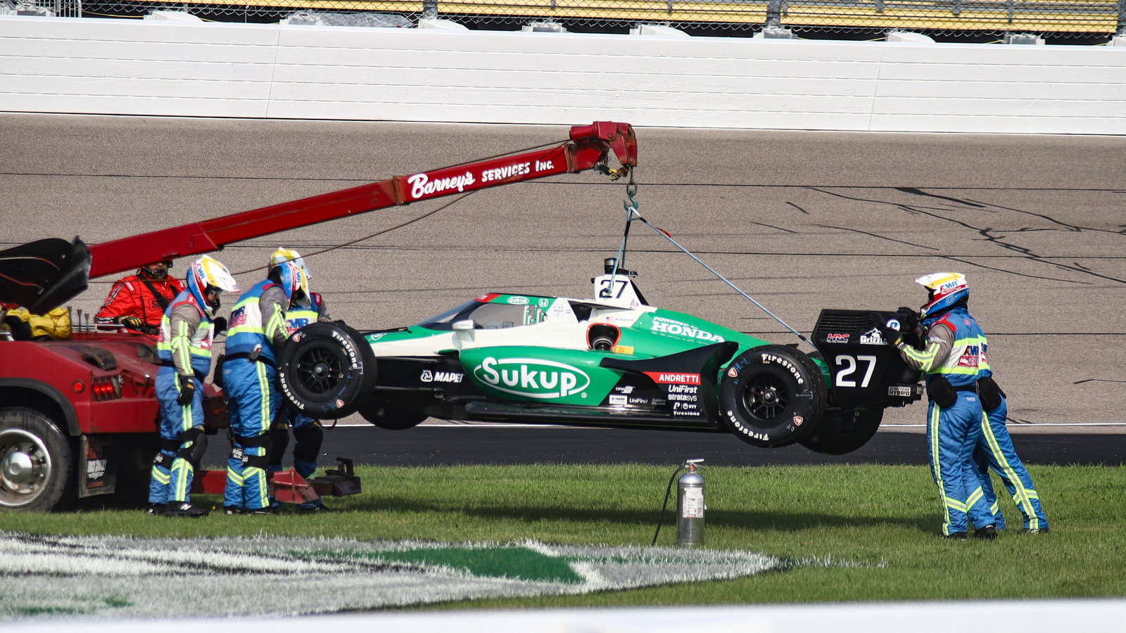 Kyle Kirkwood's car being picked up after a crash.