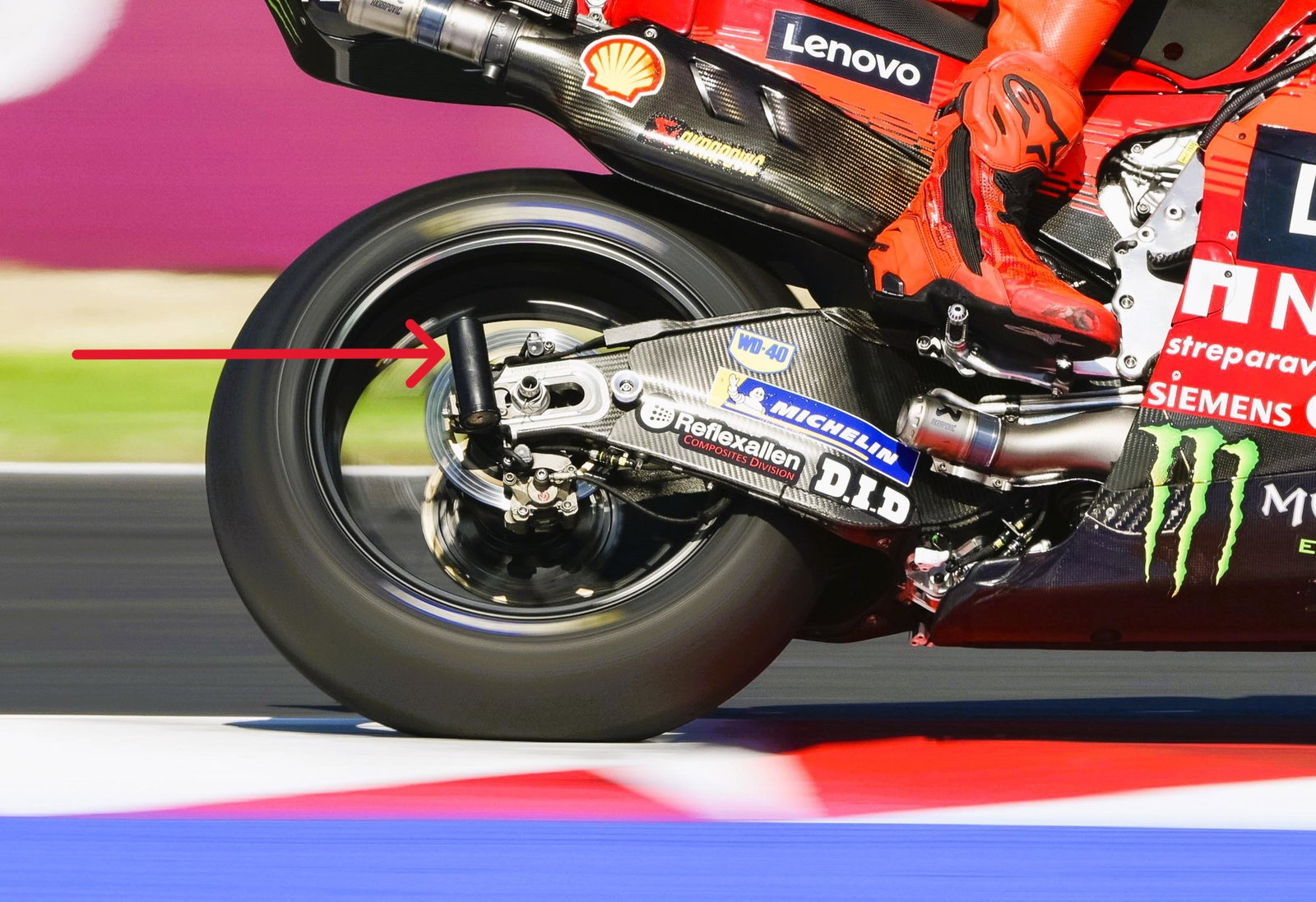 Swingarm damper (arrow) on Marc Marquez's Ducati, 2025 San Marino MotoGP