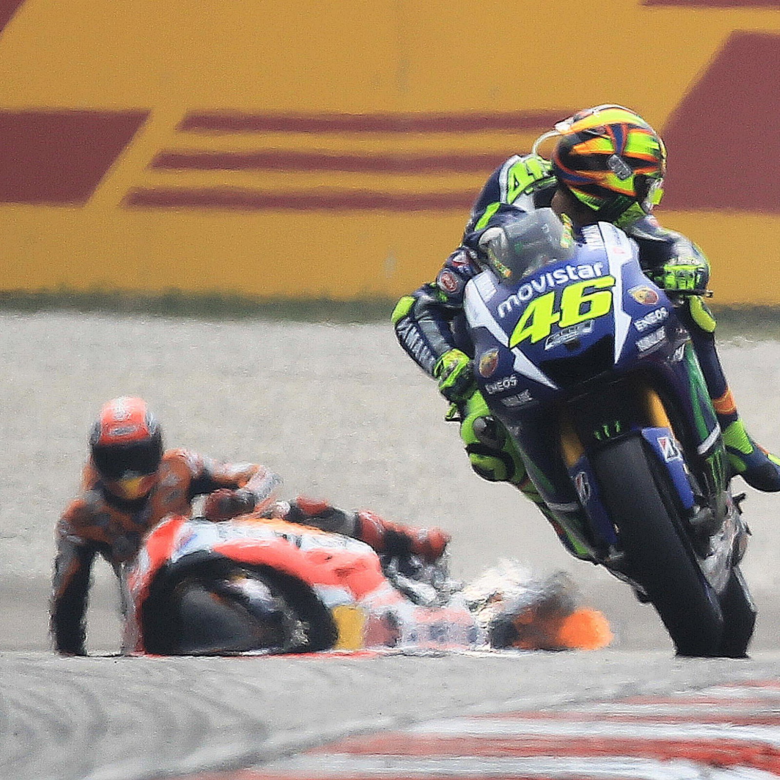 Valentino Rossi looks back at Marc Marquez on the ground, 2015 Malaysian MotoGP