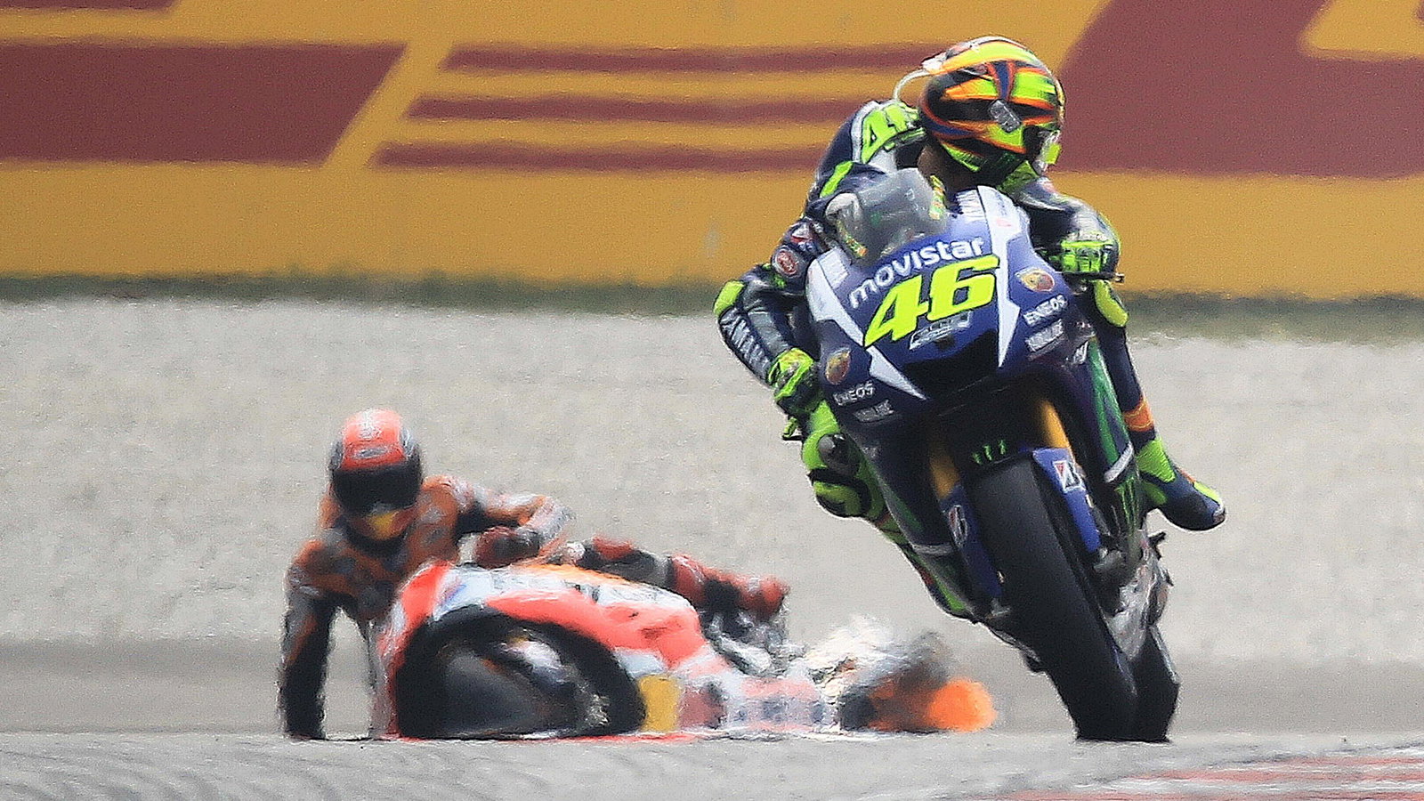 Valentino Rossi looks back at Marc Marquez on the ground, 2015 Malaysian MotoGP
