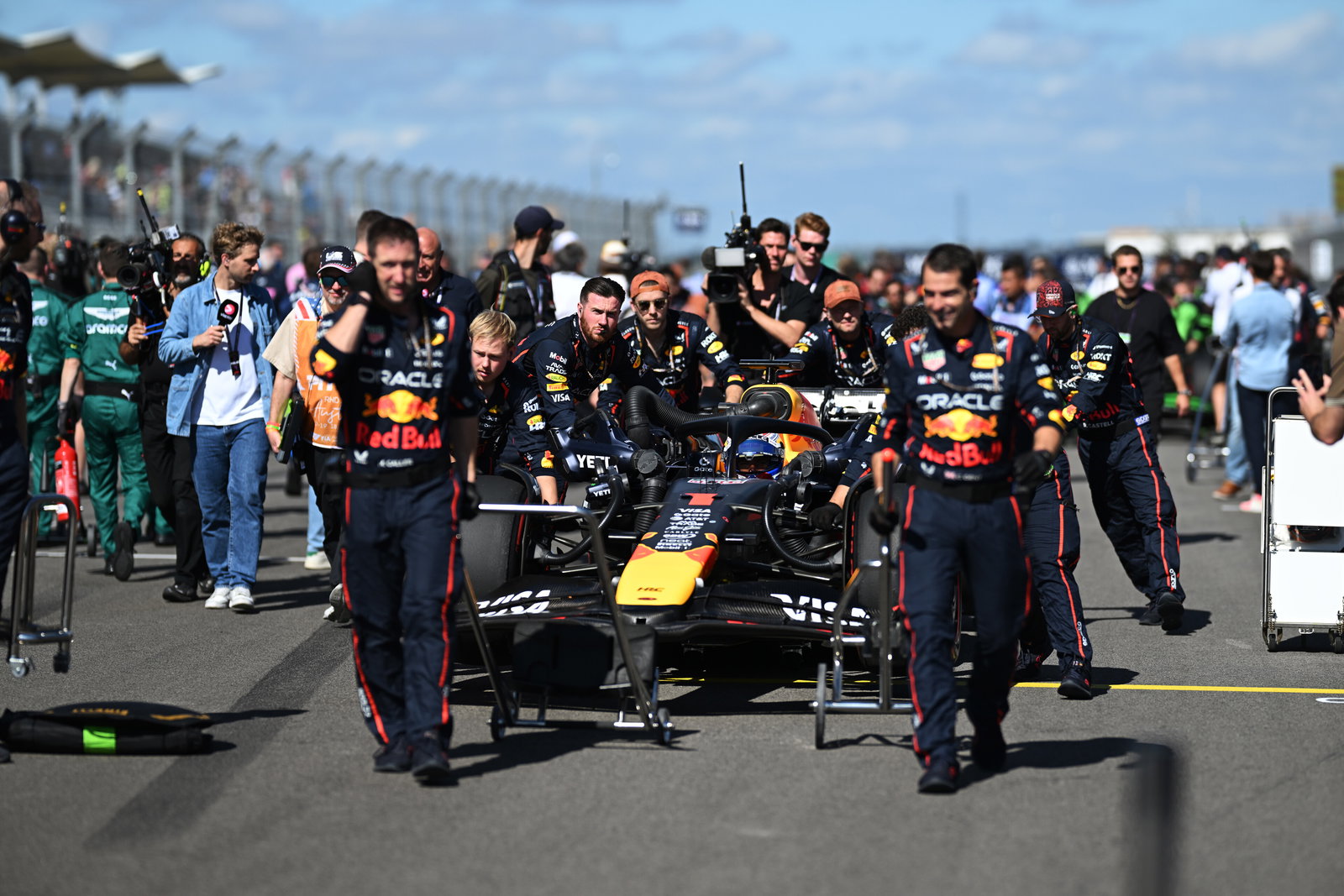 Red Bull crew wheel Max Verstappen onto the grid