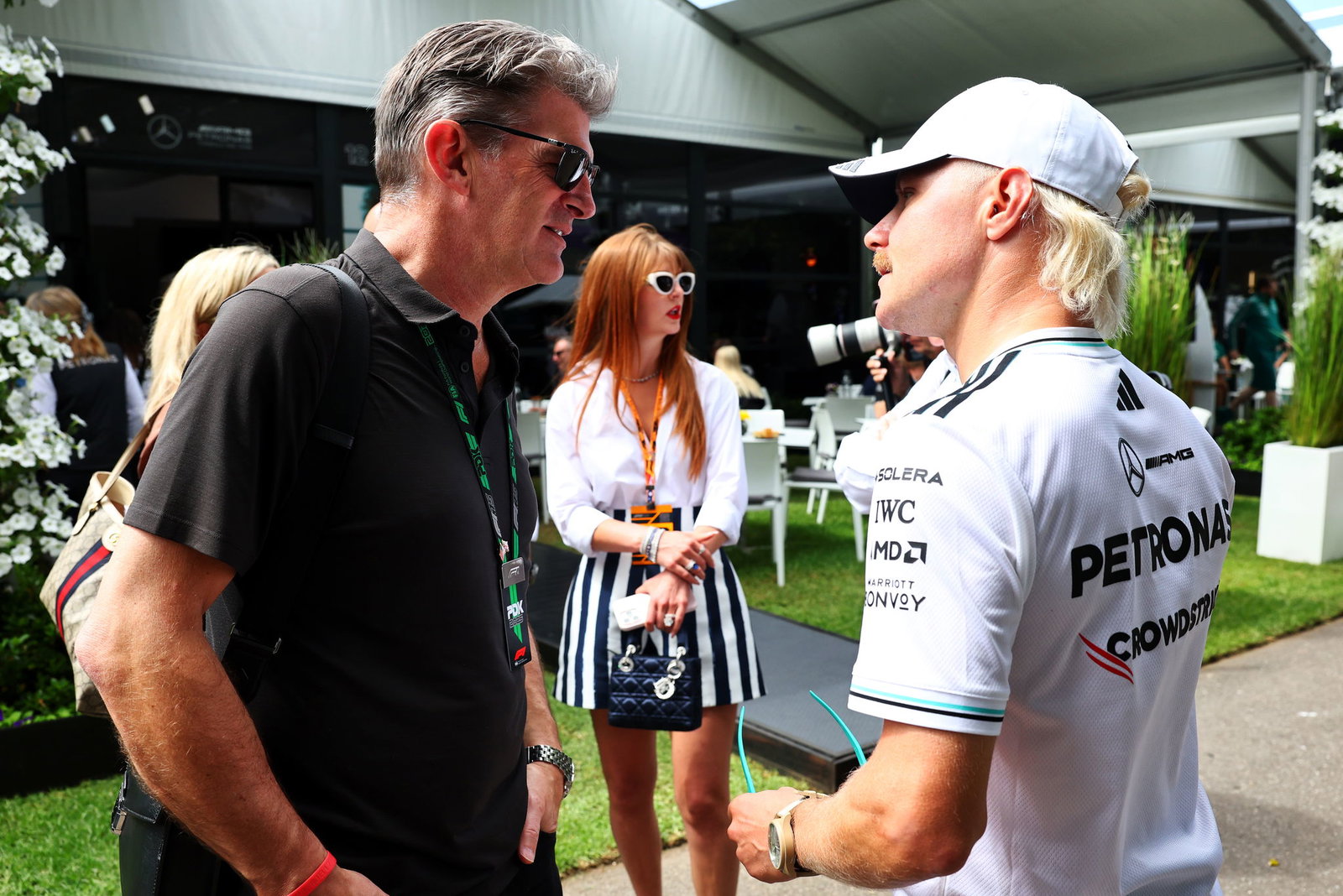 Bottas chats with Cadillac boss Lowdon in the F1 paddock