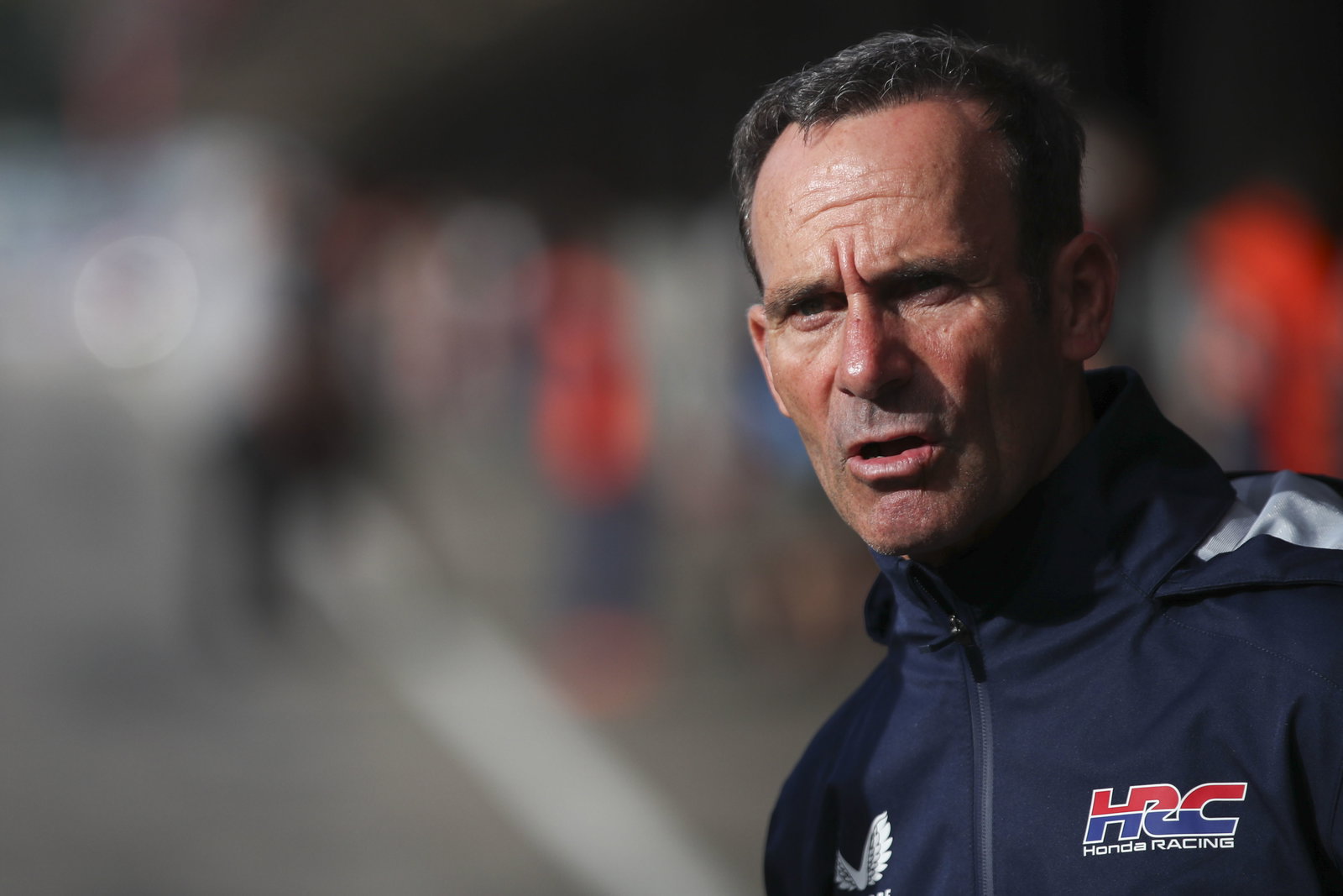 Alberto Puig, 2025 MotoGP Portuguese Grand Prix, pit lane. Credit: Gold and Goose.