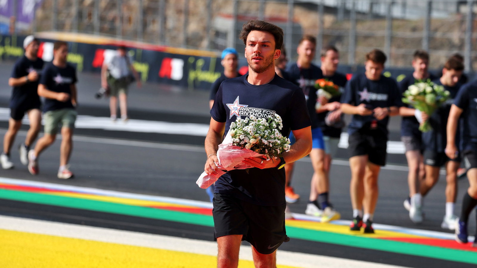 Gasly lays flowers in the now annual 'Run for Anthoine' 