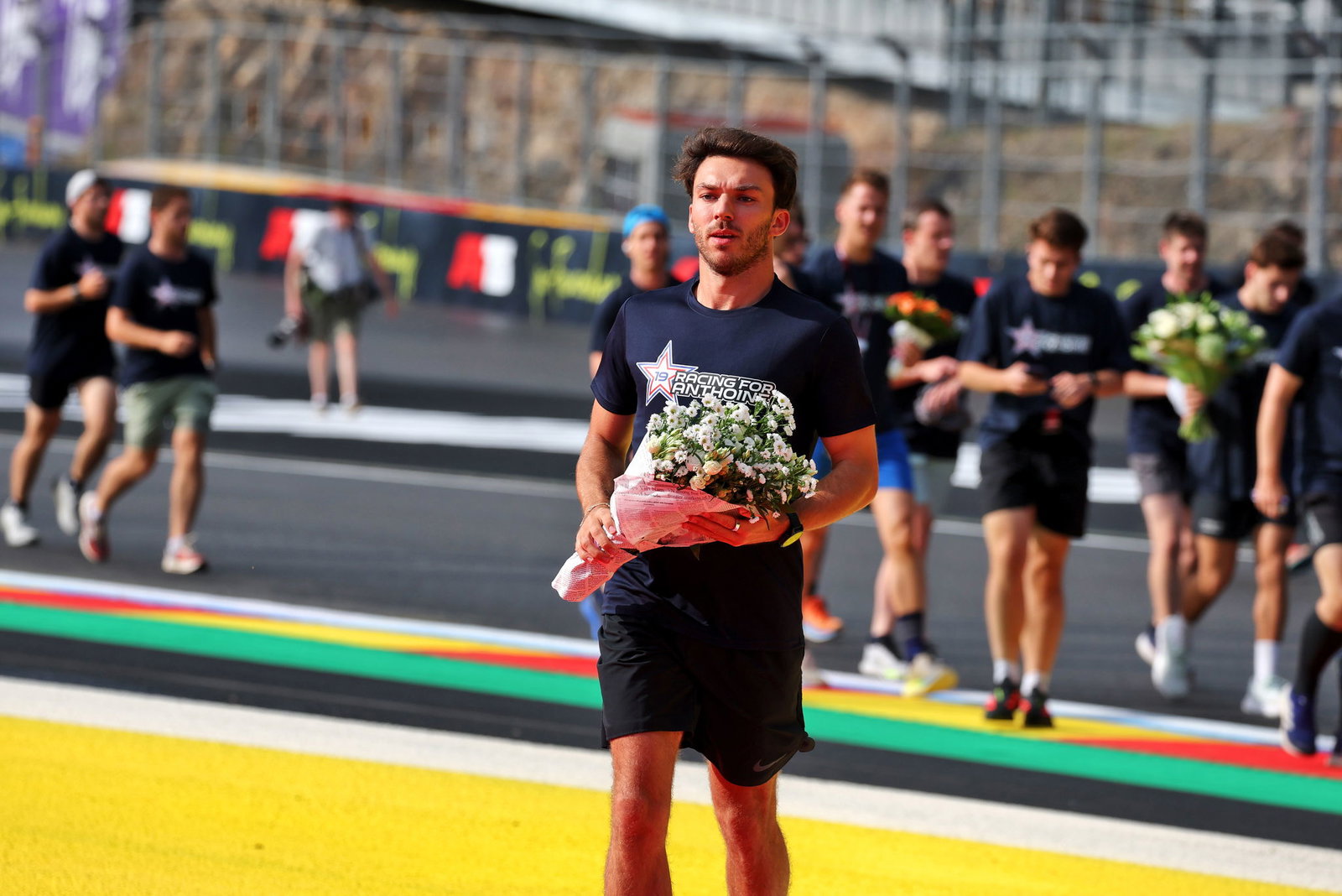 Gasly lays flowers in the now annual 'Run for Anthoine' 