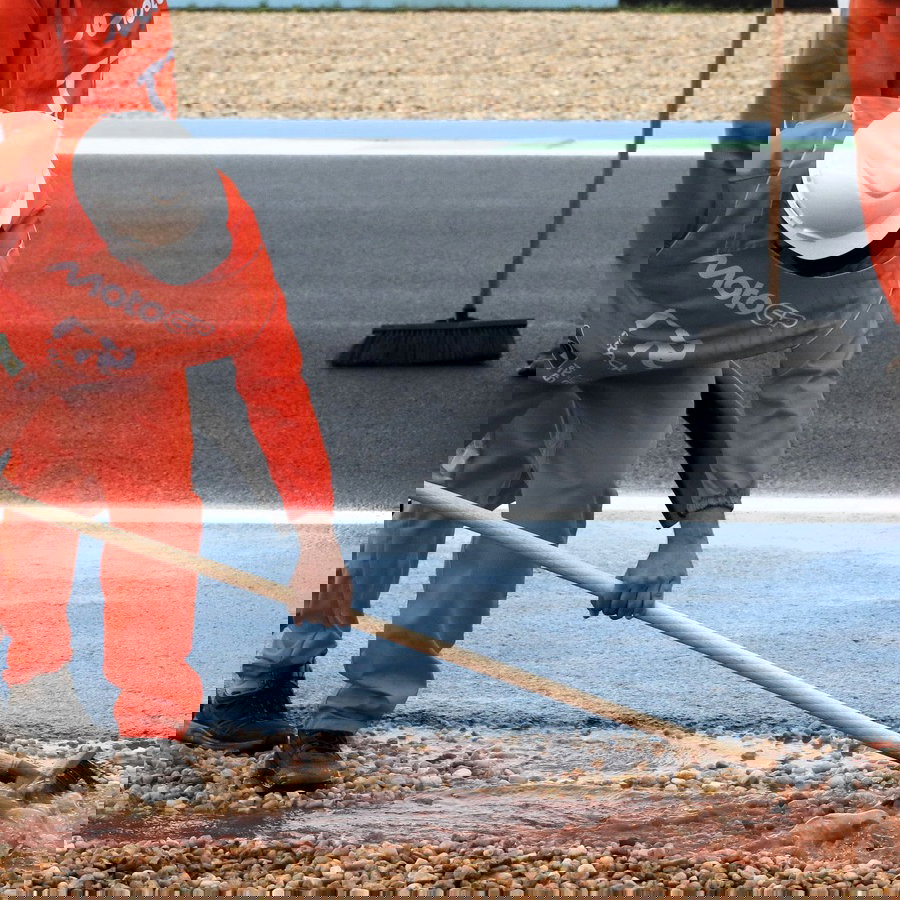  Marshals cleaning track during delayed Moto3 practice, Brazilian MotoGP, 20 March 2026