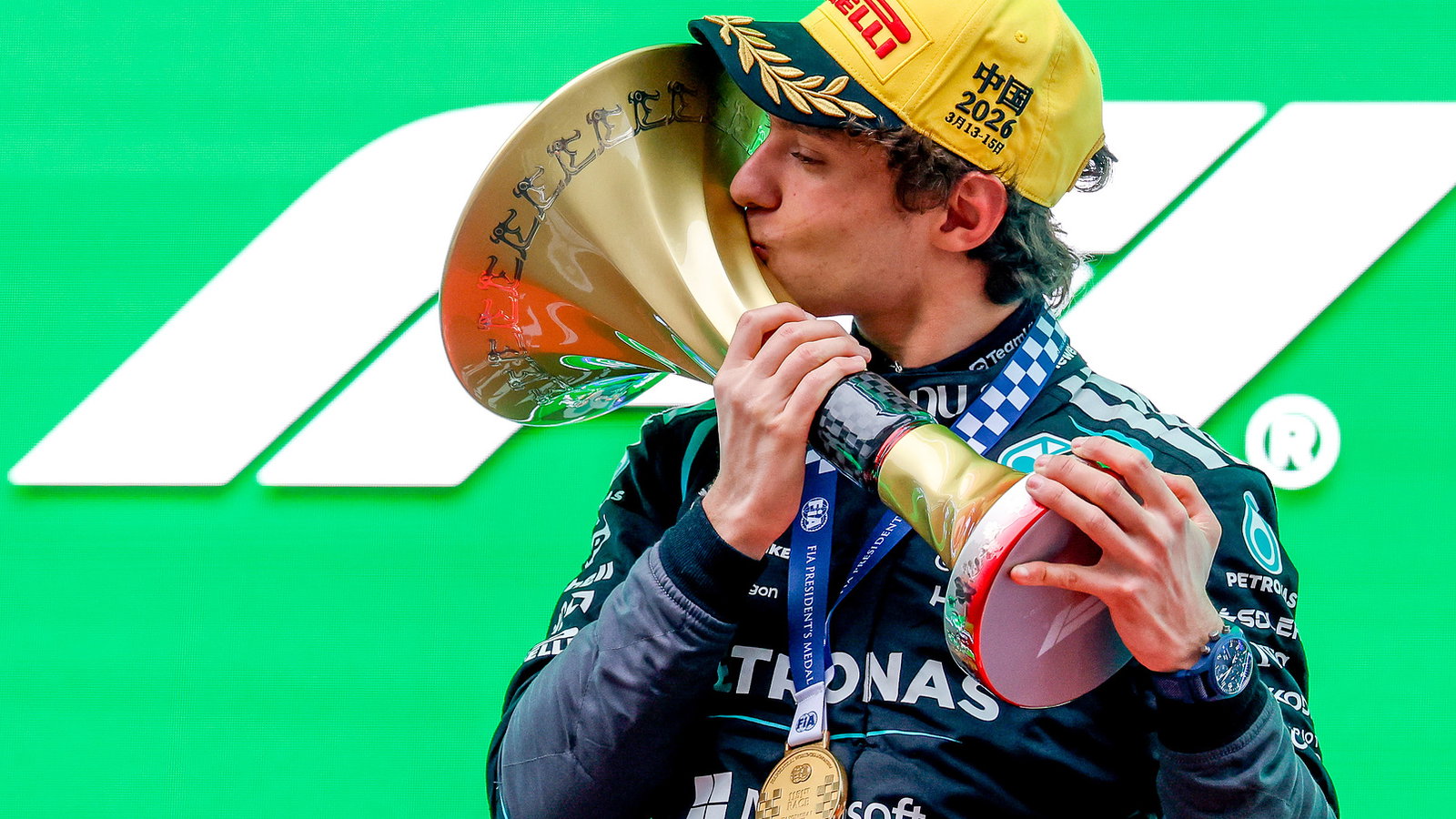 Antonelli kisses the winners' trophy on the Shanghai podium