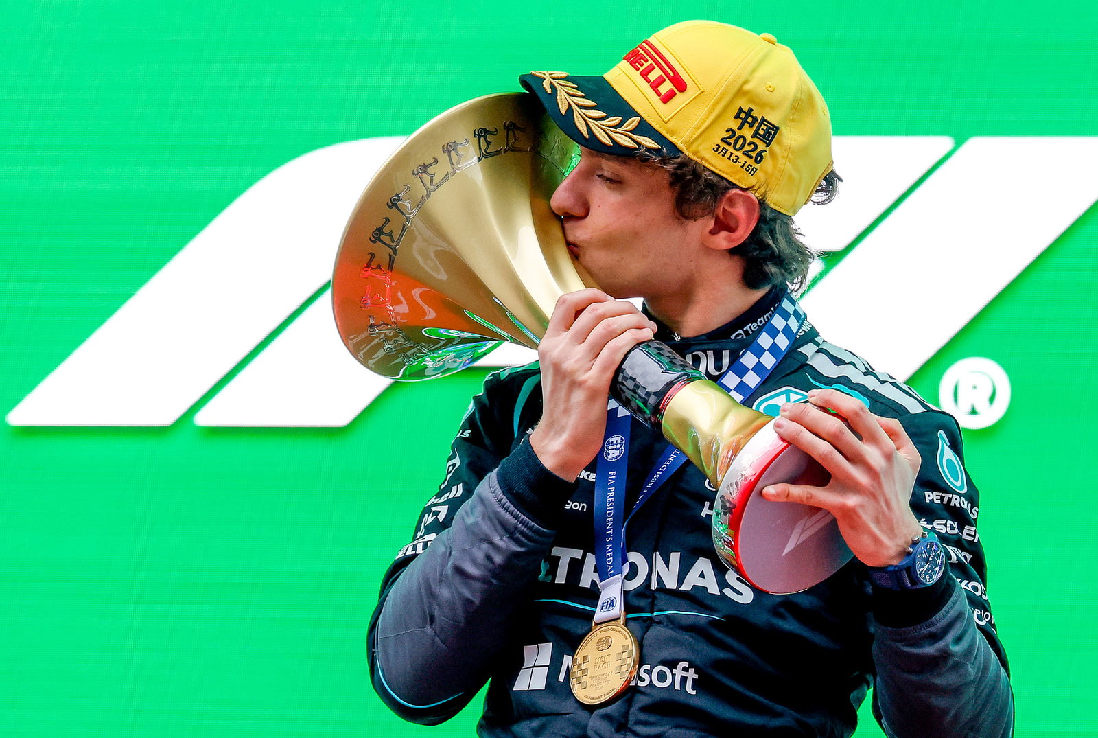 Antonelli kisses the winners' trophy on the Shanghai podium