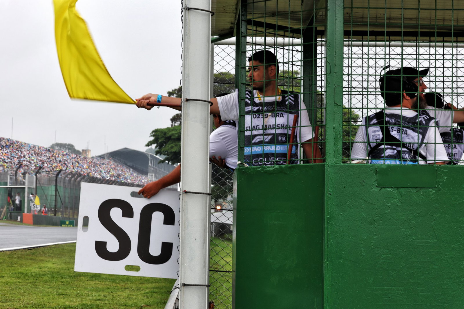 Am F1 marshal waves a yellow flag 