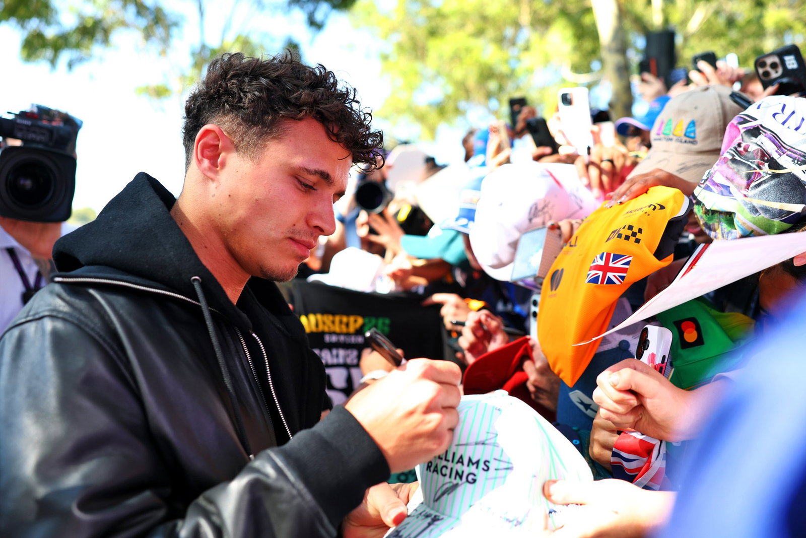 Lando Norris signs autographs for fans at Albert Park