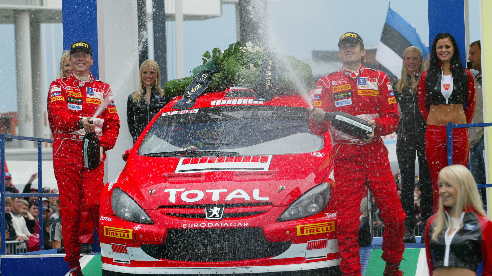 Peugeot`s Marcus Gronholm and Timo Rautiainen celebrate their Rally Finland win