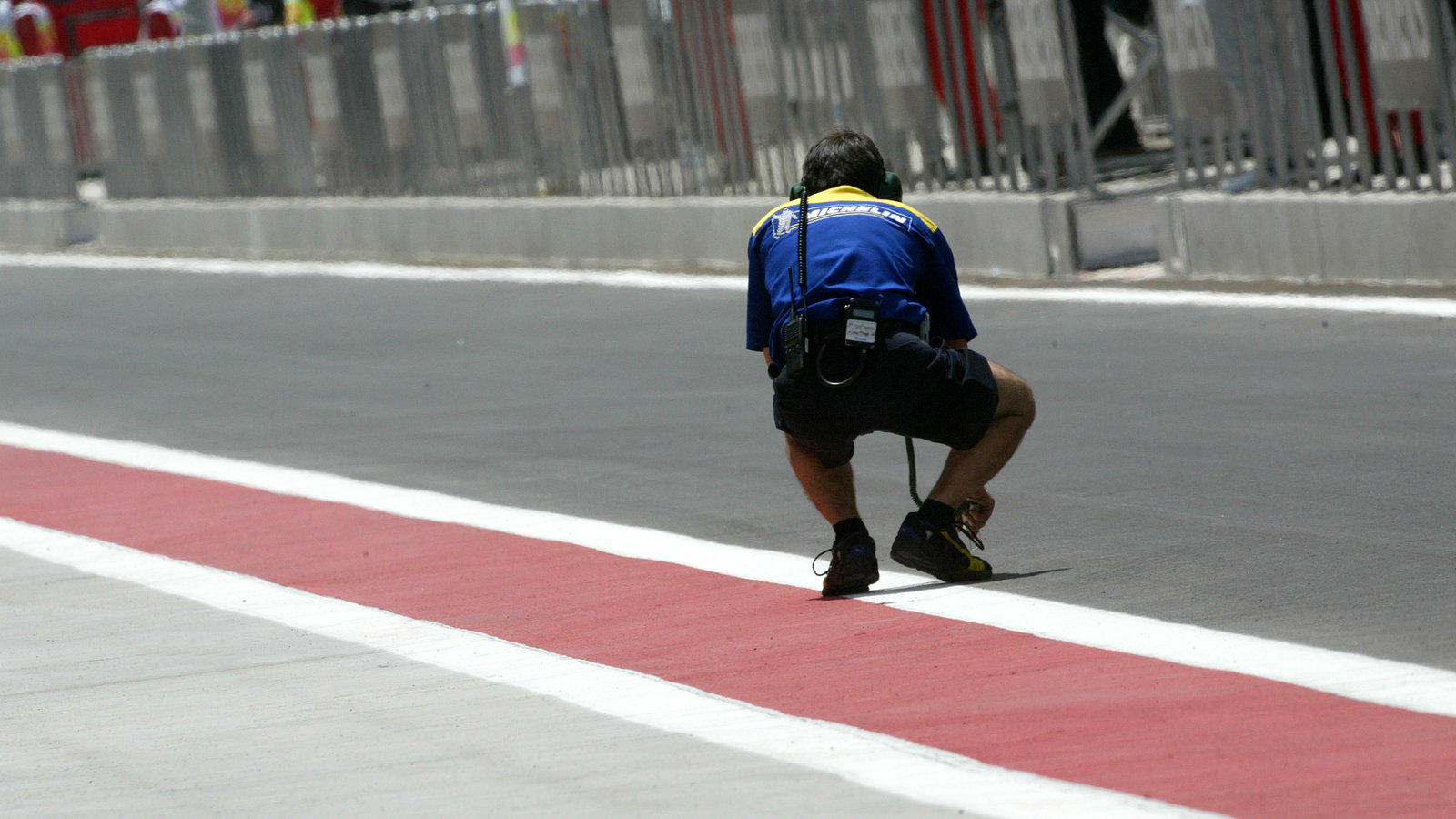 A Michelin tyre technician checks the track temperature in Bahrain