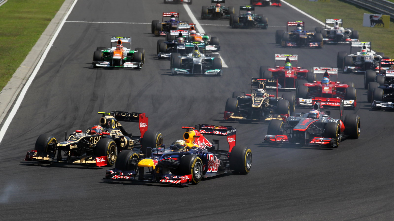 29.07.2012- Race, Start of the race, Romain Grosjean (FRA) Lotus F1 Team E20 and Sebastian Vettel (G