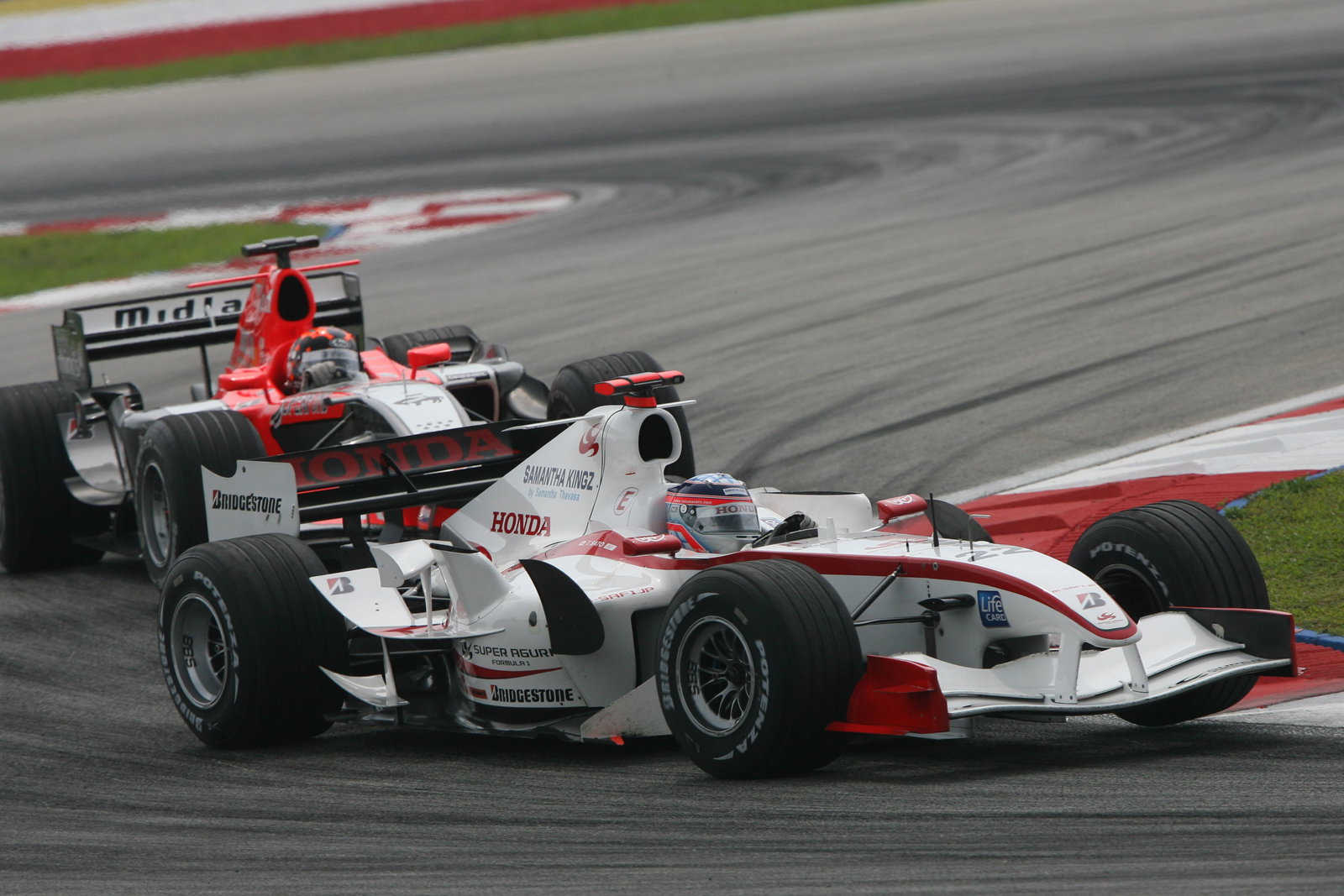 Takuma Sato (Super Aguri) battles with Christijan Albers (Midland MF1)