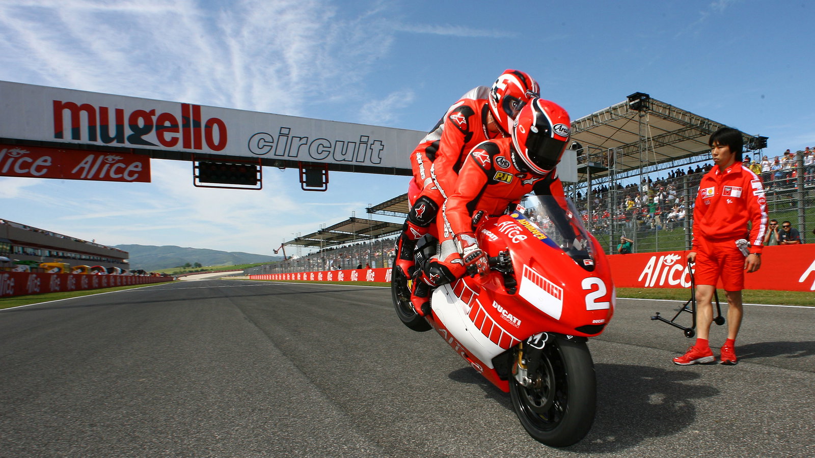 Mamola and Schumacher do a stoppie at end of two seater ride, Italian MotoGP, 2006