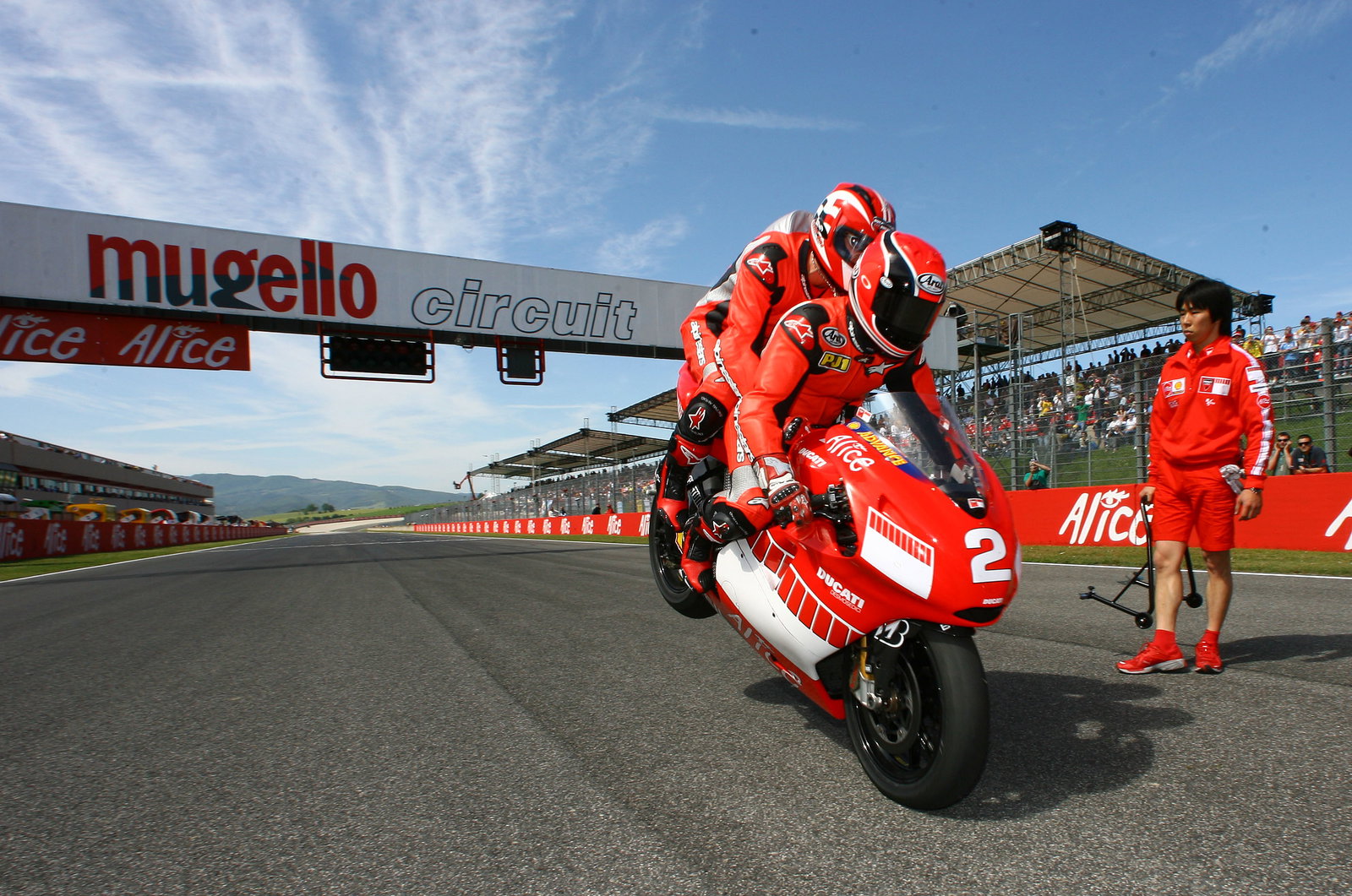 Mamola and Schumacher do a stoppie at end of two seater ride, Italian MotoGP, 2006