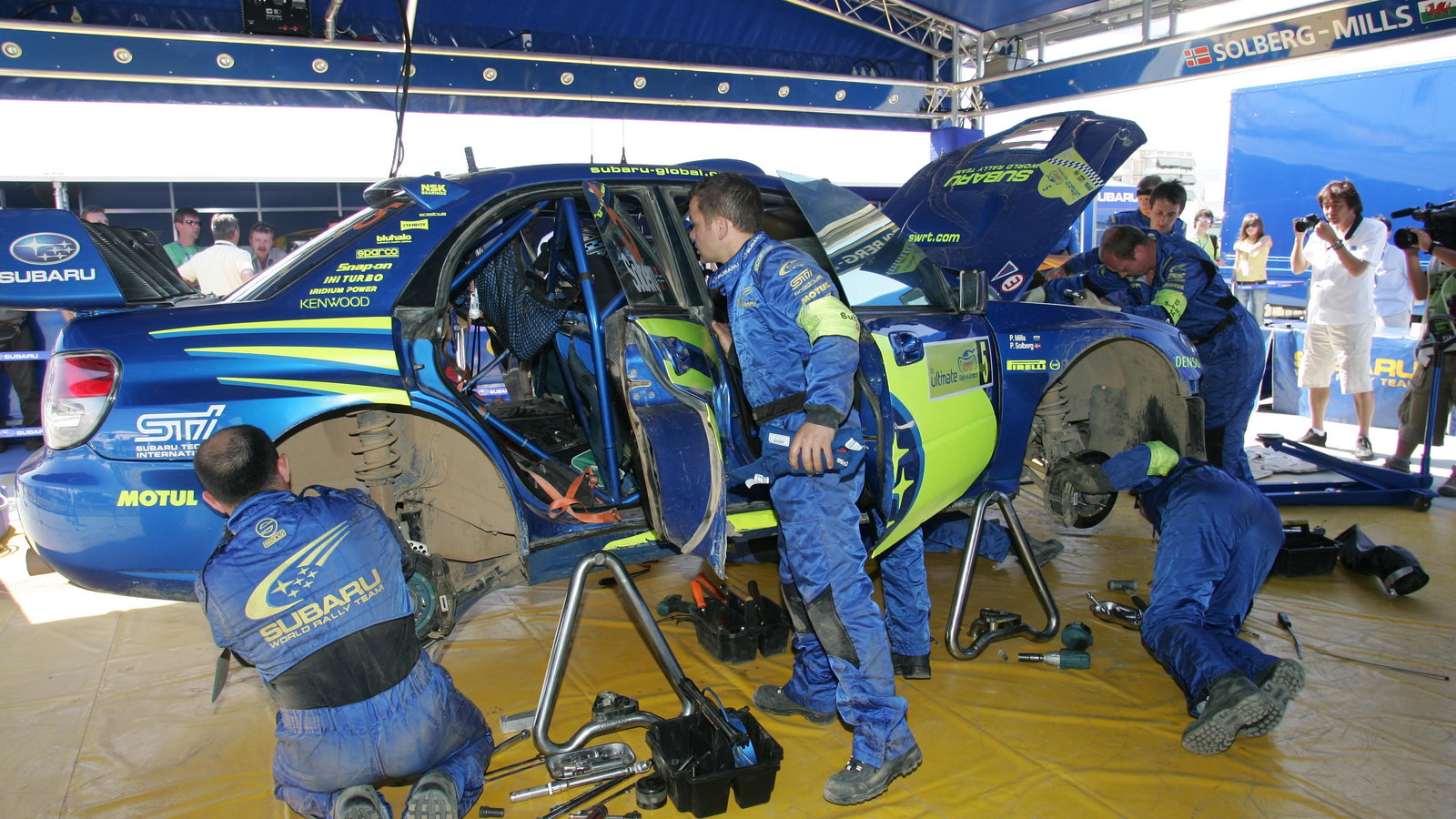 Subaru WRT mechanics work on Petter Solberg`s Impreza at the Acropolis Rally
