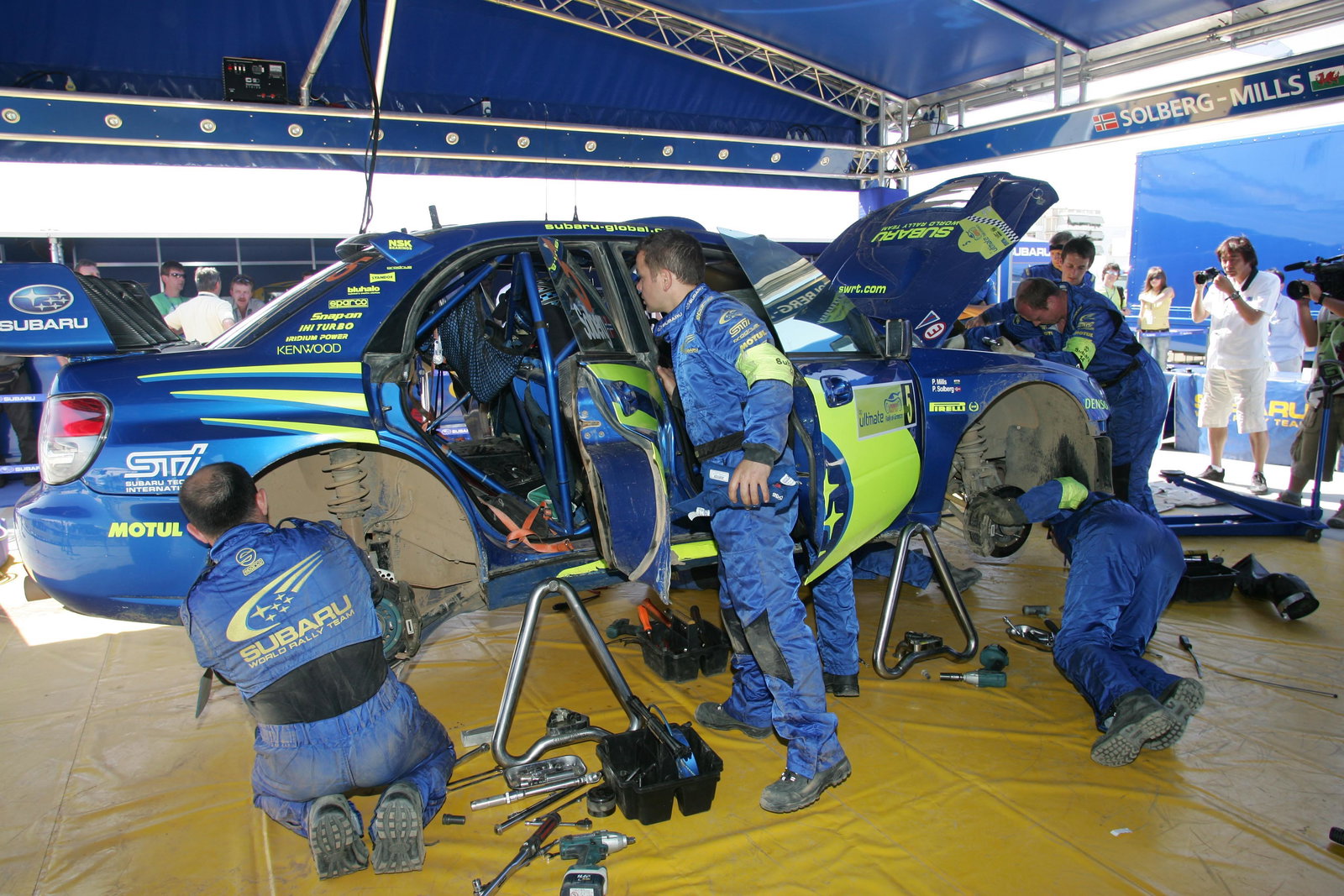 Subaru WRT mechanics work on Petter Solberg`s Impreza at the Acropolis Rally