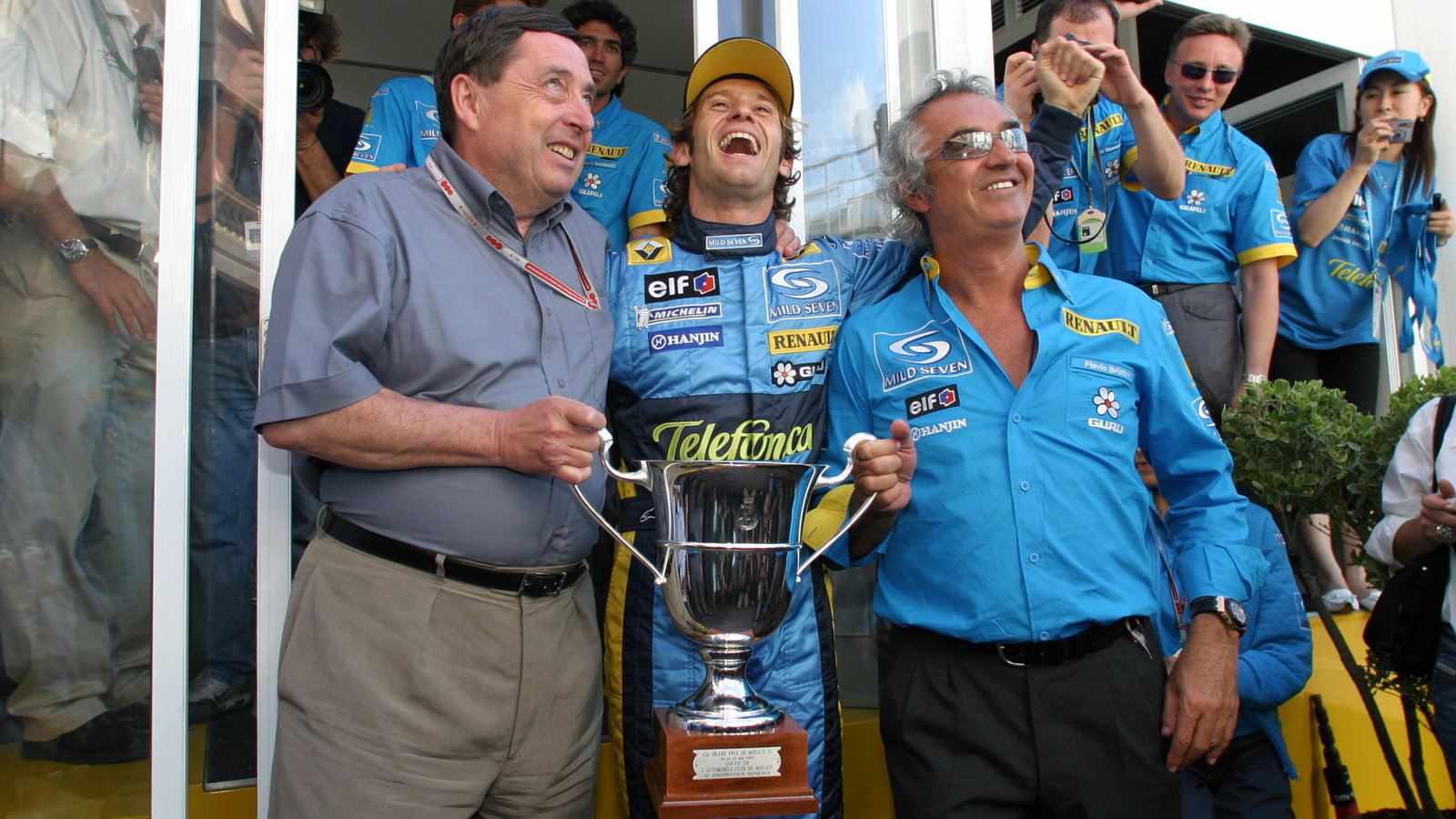 Jarno Trulli celebrates his first F1 grand prix win with Renault`s Patrick Faure and team principal 