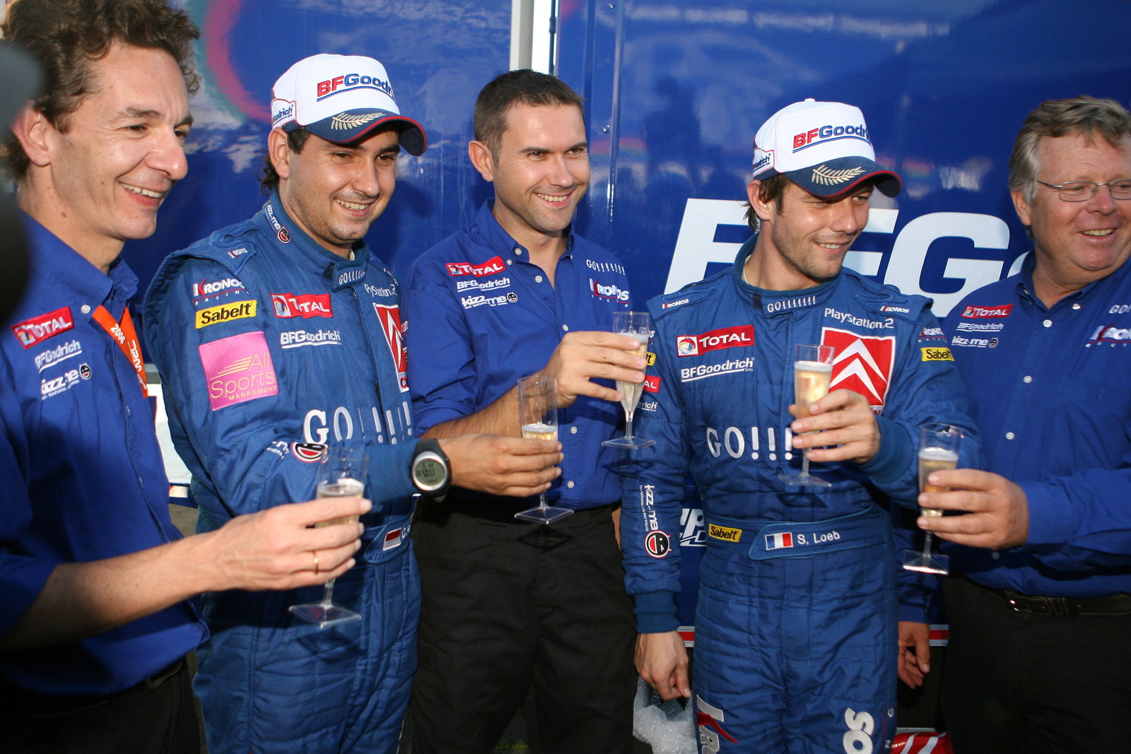 Sebastien Loeb and Daniel Elena celebrate their Cyprus win with Kronos boss, Marc van Dalen and co W