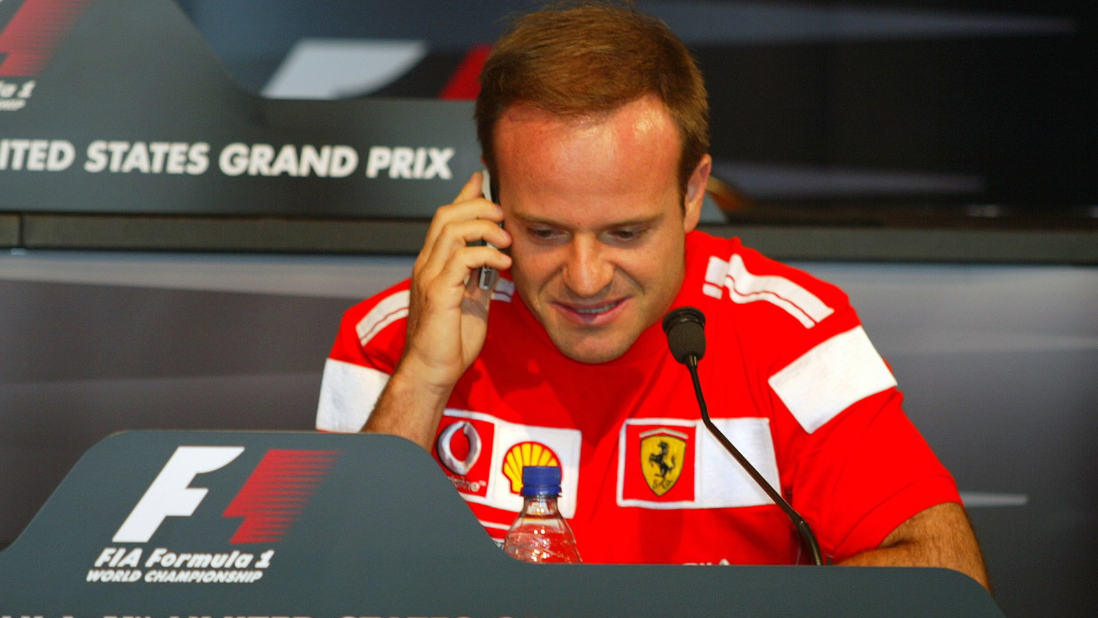 Rubens Barrichello answers a call on Ross Brawn`s mobile from fellow Ferrari F1 man Rory Byrne at th