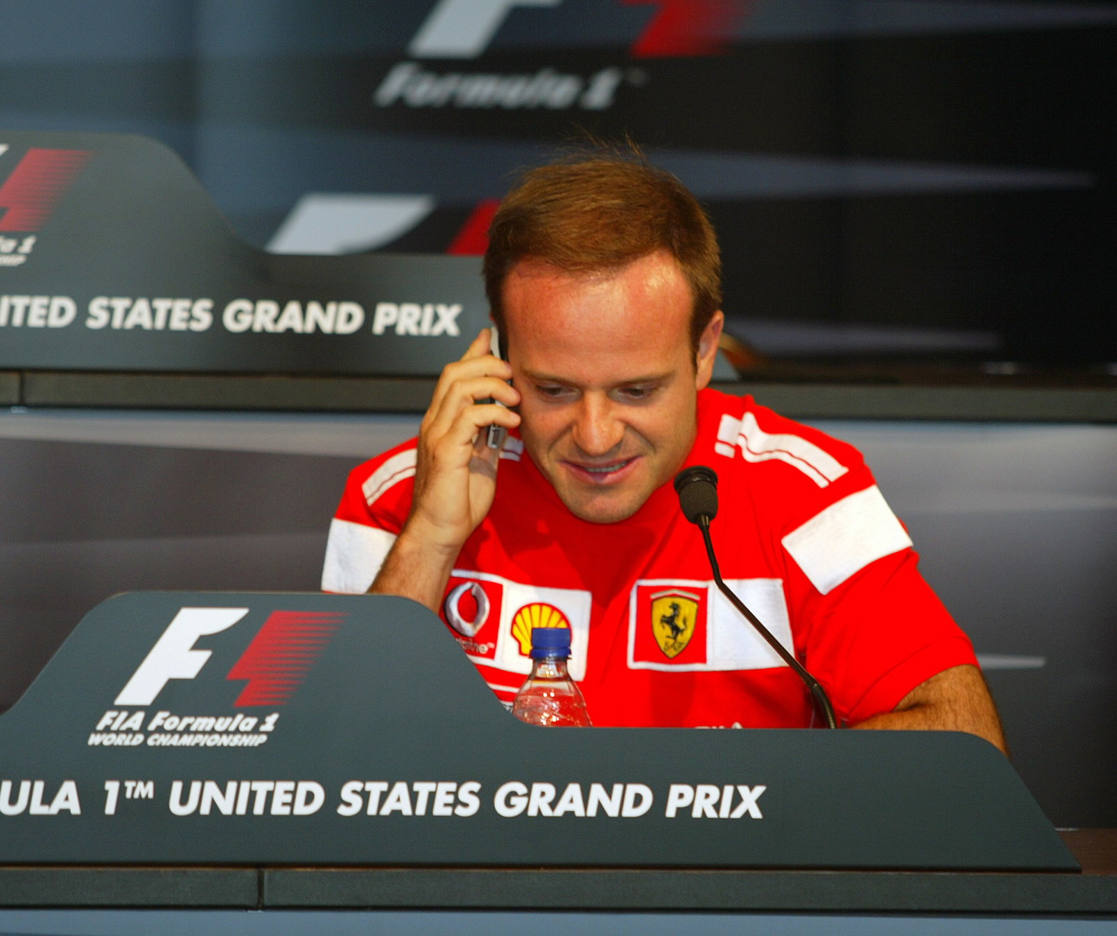 Rubens Barrichello answers a call on Ross Brawn`s mobile from fellow Ferrari F1 man Rory Byrne at th