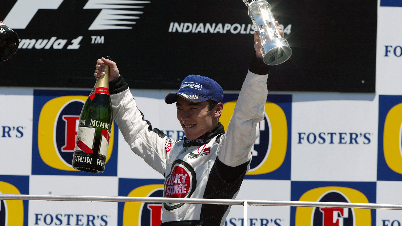 BAR-Honda`s Takuma Sato celebrates his third place finish at the US GP
