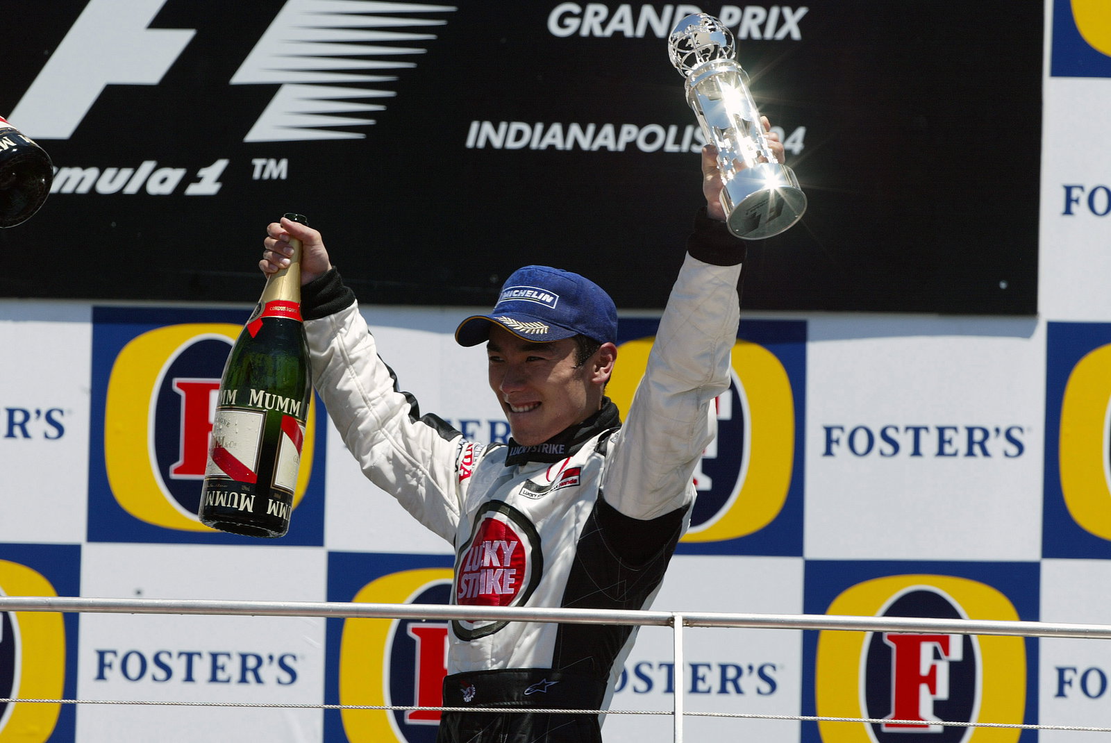 BAR-Honda`s Takuma Sato celebrates his third place finish at the US GP