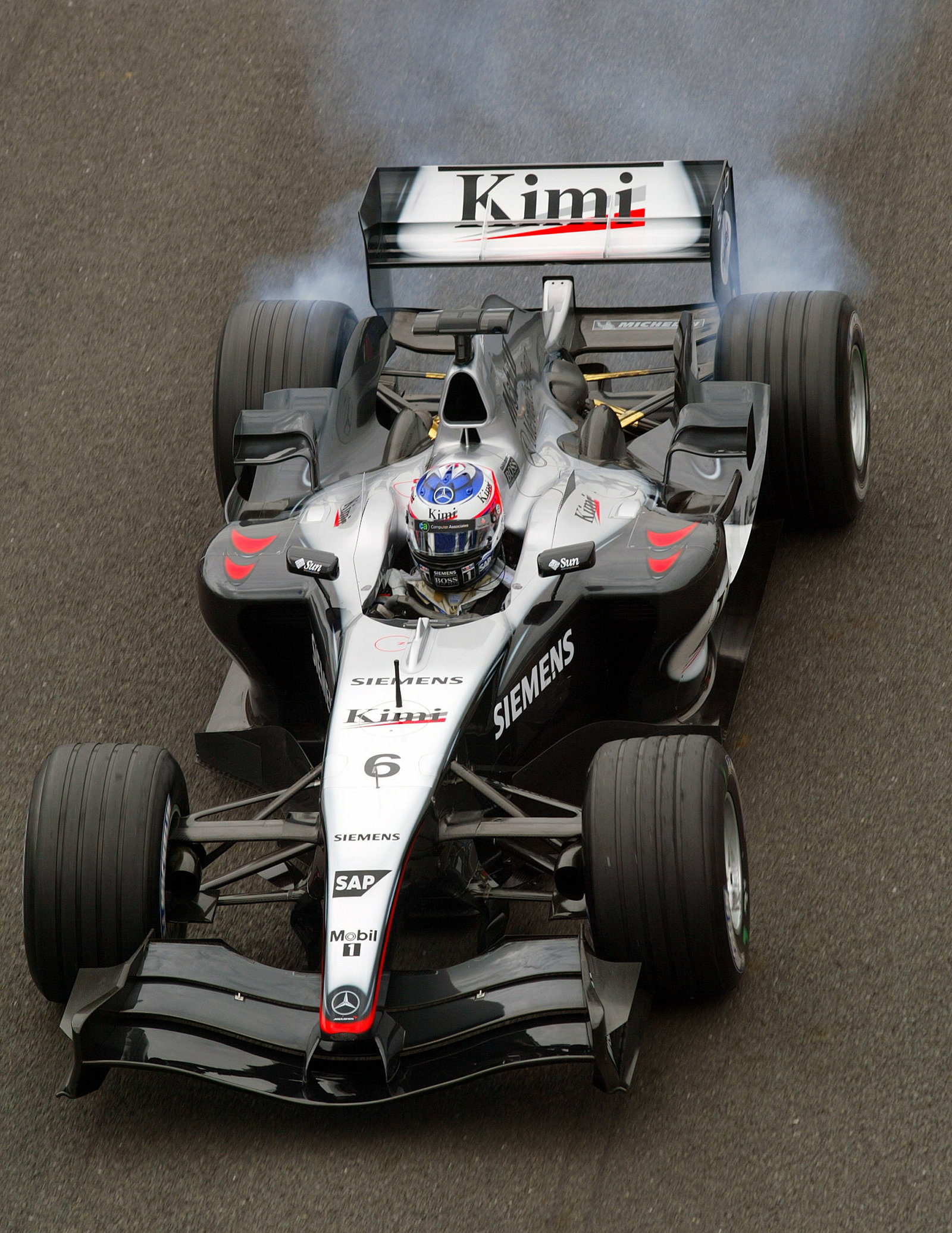 Kimi Raikkonen, McLaren Mercedes lights up his tyres as he sets off on his final parade lap before t