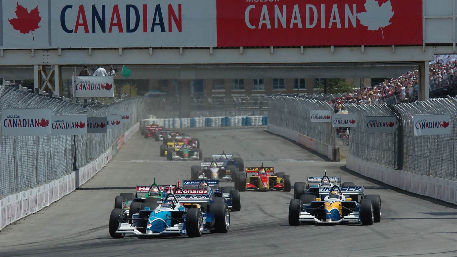 Paul Tracy gets the jump on Forsythe teammate Rodolfo Lavin at the start of the 2004 Molson Indy Van