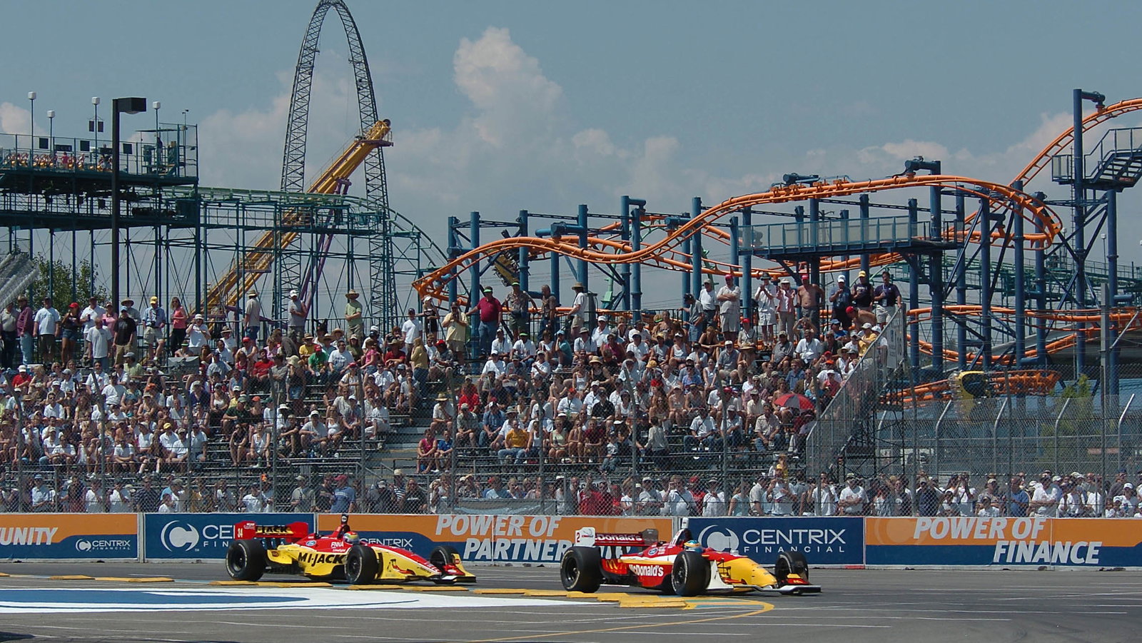 Sebastien Bourdais heads Justin Wilson into the first turn in Denver