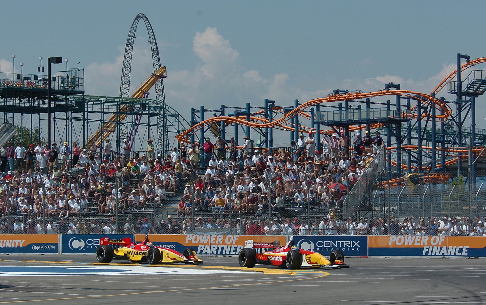 Sebastien Bourdais heads Justin Wilson into the first turn in Denver