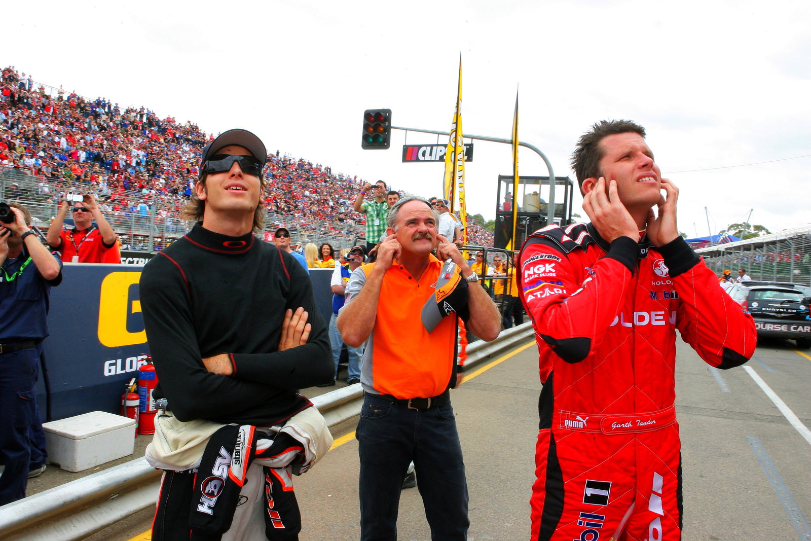 Rick Kelly (L) his dad and team owner (John Kelly (C) and Garth Tander (R) former team mate watch th