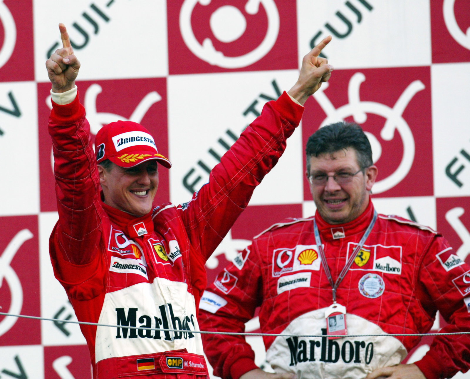 Michael Schumacher and Ross Brawn celebrate another perfect race at the 2004 Japanese Grand Prix