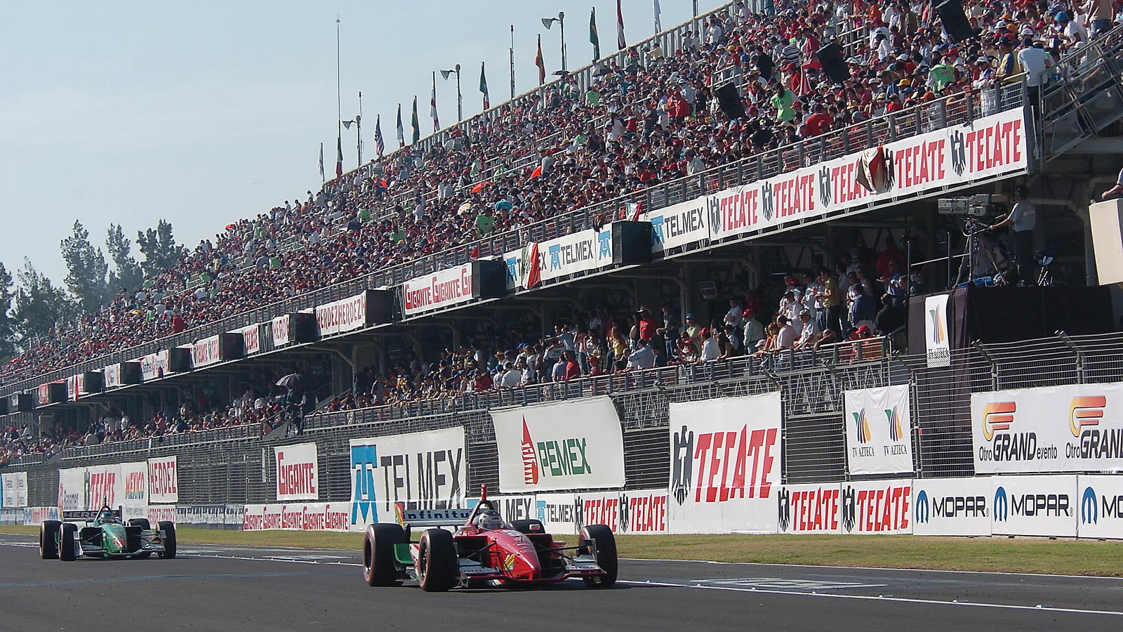 Michel Jourdain Jr and Ryan Hunter-Reay pass Mexico City`s gigantic main grandstand