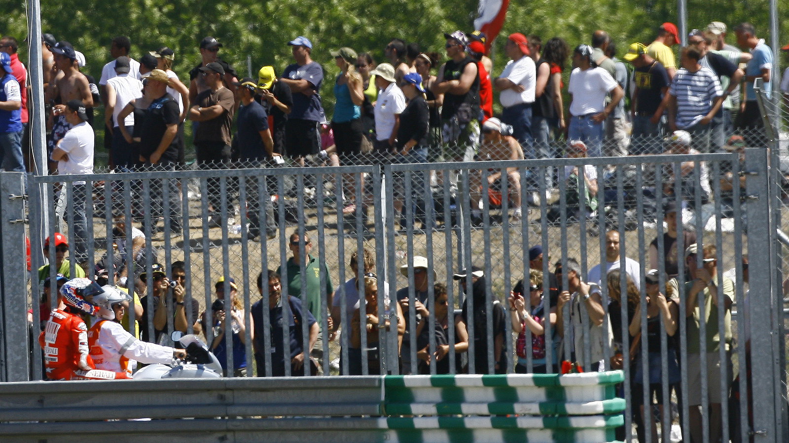 Stoner on back of scooter after crashing, French MotoGP 2010
