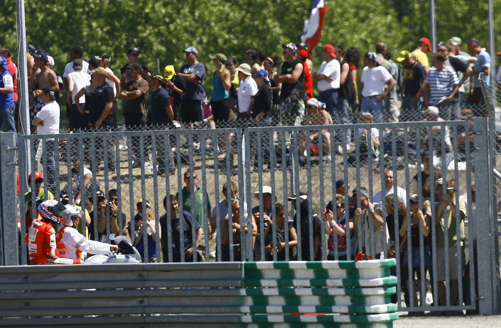 Stoner on back of scooter after crashing, French MotoGP 2010