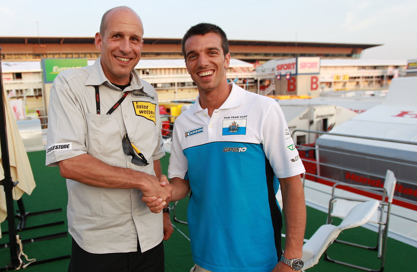 Daniel Epp and De Angelis shaking hands on Interwetten Honda MotoGP ride, Catalunya MotoGP 2010
