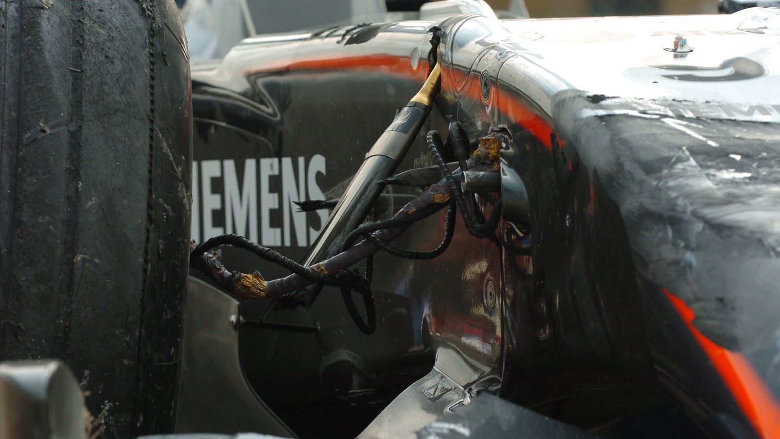 The damaged McLaren Mercedes of Kimi Raikkonen is returned to the Nurburgring pit-lane