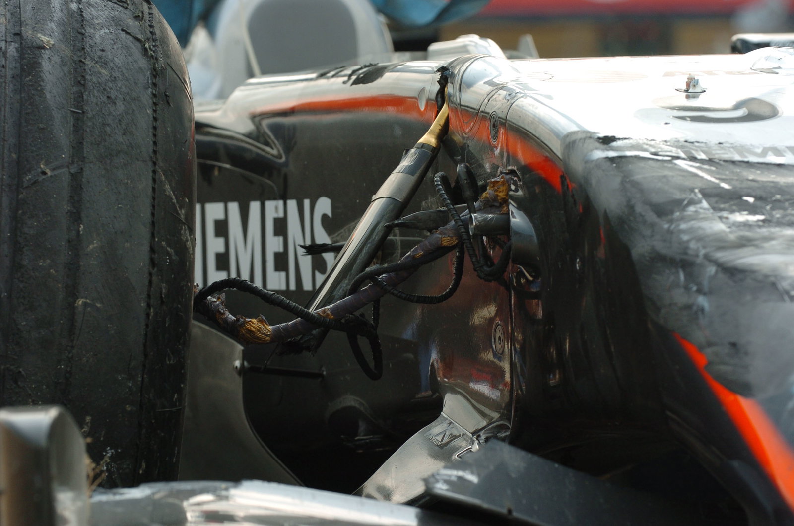 The damaged McLaren Mercedes of Kimi Raikkonen is returned to the Nurburgring pit-lane