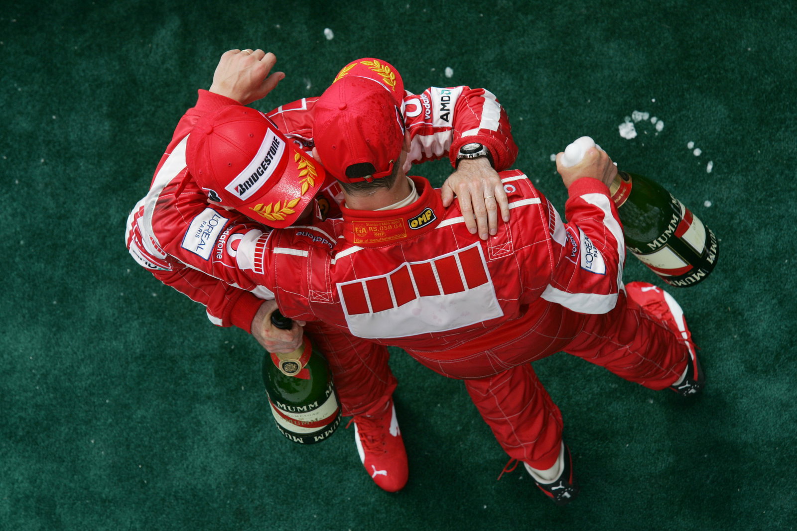 Michael Schumacher and Rubens Barrichello celebrate a Ferrari podium double in Canada