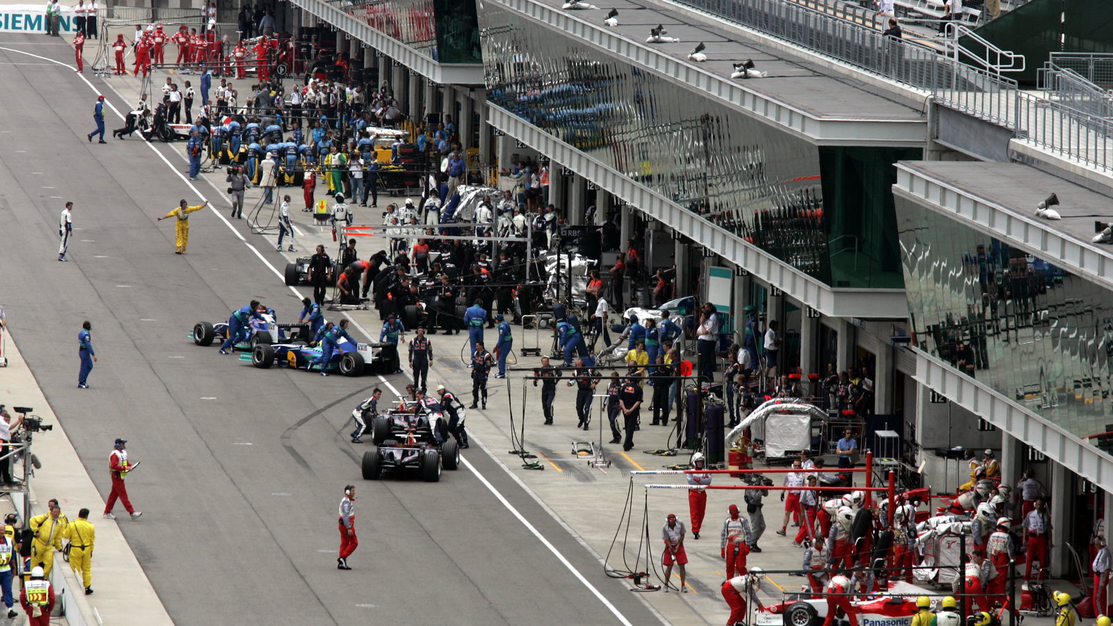 The Michelin cars pull back into their pit garages at the start of the United States Grand Prix