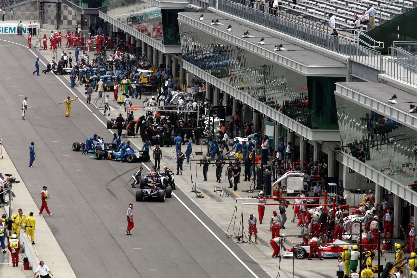 The Michelin cars pull back into their pit garages at the start of the United States Grand Prix