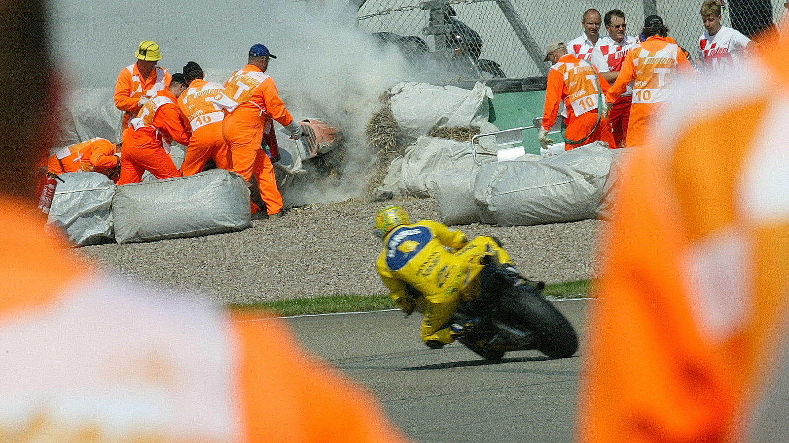 Barros rides past Byrne`s crash, German MotoGP, 2005