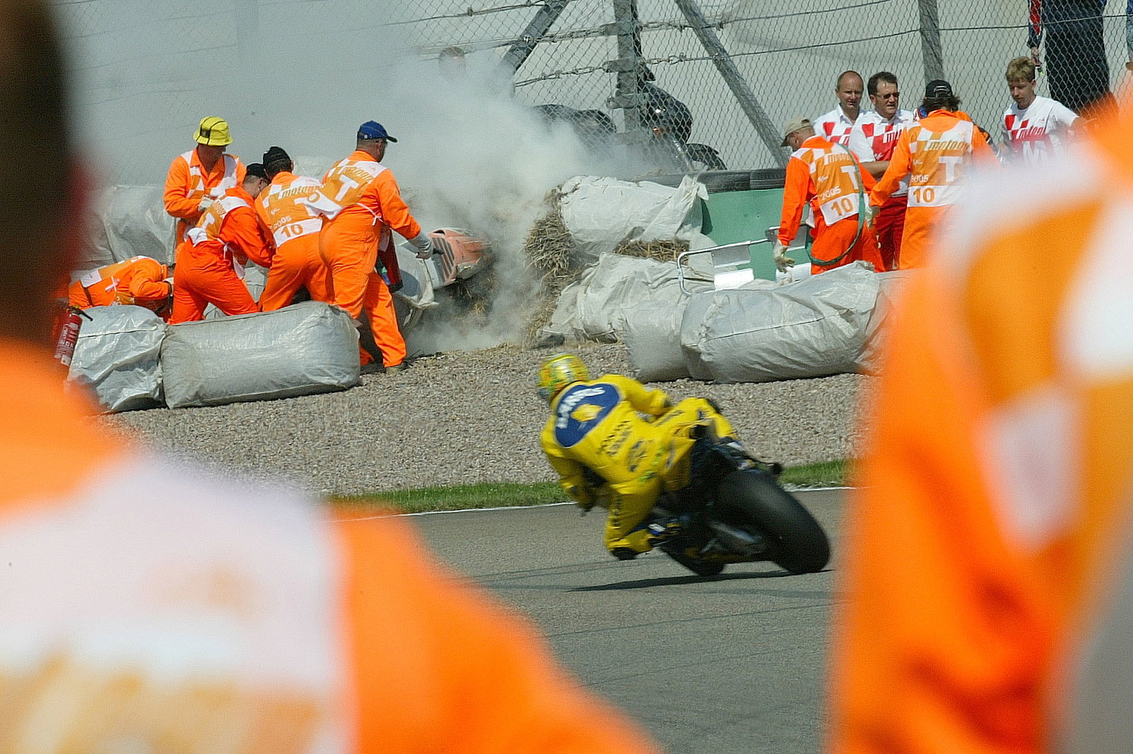 Barros rides past Byrne`s crash, German MotoGP, 2005