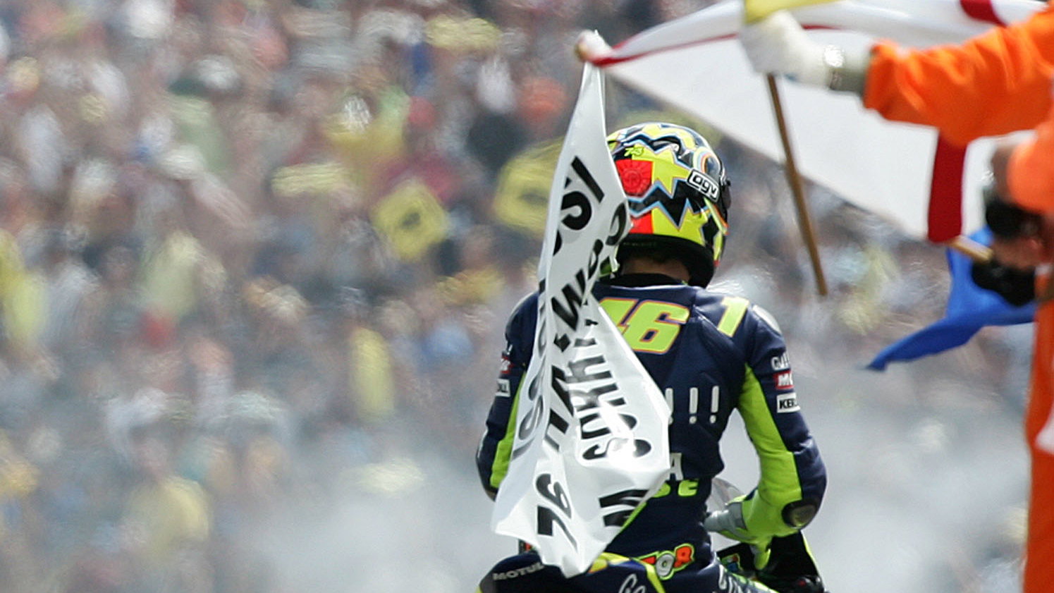 Rossi celebrates with Hailwood flag, German MotoGP, 2005
